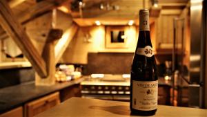 a bottle of wine sitting on a table in a kitchen at Chalet Geneviève in Sainte-Foy-Tarentaise