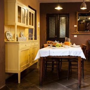a kitchen with a table with a plate of food on it at La Corte di Alzo in Pella