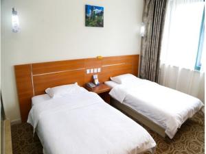 a hotel room with two beds and a window at Thank Inn Chain Hotel Jiangsu Wuxi New District Taibo Avenue in Wuxi