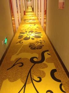 a hallway with a patterned floor in a building at Thank Inn Chain Hotel Hebei Langfang the 6th Street in Langfang
