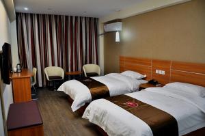 เตียงในห้องที่ Thank Inn Chain Hotel Henan Xinyang Shangcheng County Huayuan Road