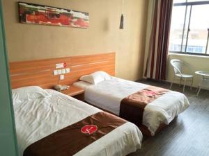 a hotel room with two beds and a table at Thank Inn Chain Hotel Jiangsu Yixing Dingshu Town East Jiefang Road in Zhoushu
