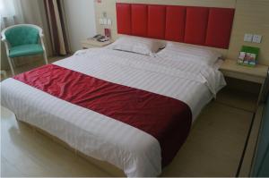 a bedroom with a large bed with a red headboard at Thank Inn Chain Hotel Hebei Zhangjiakou Guyuan County Yingbin Avenue in Guyuan