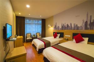 a hotel room with two beds and a flat screen tv at Thank Inn Chain Hotel Sichuan Guangan Wusheng County Hongwu Avenue in Wusheng