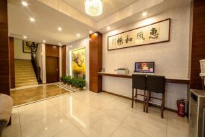 a lobby with a staircase in a building at JUNYI Hotel Jiangsu Yancheng Tinghu District Jinying International Shopping Center in Yancheng