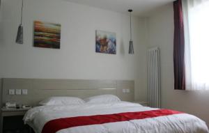 1 dormitorio con 1 cama con manta roja y blanca en Thank Inn Chain Hotel Hebei Cangzhou Qing County Jingfu Avenue, en Qing