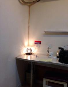 a room with a desk with a light on it at Thank Inn Chain Hotel Hebei Cangzhou West Jiefang Road in Cangzhou