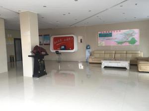a lobby with a couch and a tv in a building at Thank Inn Chain Hotel Hebei Zhangjiakou Guyuan County Yingbin Avenue in Guyuan
