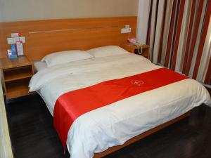 a large bed with a red and white blanket at Thank Inn Chain Hotel Zibo Road in Dongying