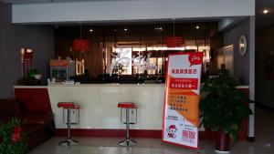 a restaurant with a sign in front of a counter at Thank Inn Chain Hotel Hebei Cangzhou Qing County Nanhuan Road in Qing