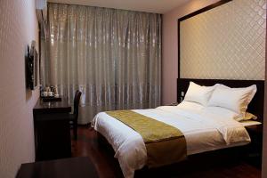 Posteľ alebo postele v izbe v ubytovaní JUNYI Hotel Jiangsu Lianyungang South Junan Road