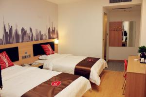 a hotel room with two beds and a desk at Thank Inn Plus Hotel Shandong Daminghu in Jinan