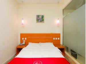 a bedroom with a large bed with a red blanket at Thank Inn Chain Hotel Jiangsu Wuxi New District Taibo Avenue in Wuxi