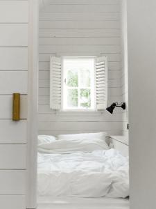 a white bedroom with a bed and a window at Castle View in Lancaster