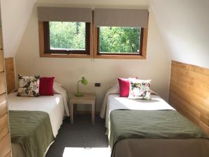 En eller flere senger på et rom på Cabañas Posada Alemana