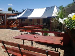 a group of picnic tables and benches with a tent at The Highland Inn in Bethlehem