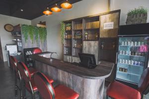 a bar with red chairs in a restaurant at V3 Hotel & Residence Seri Alam in Pasir Gudang +25 photos