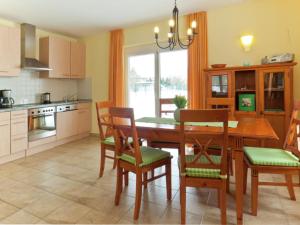 a kitchen with a wooden dining room table and chairs at Comfortable Holiday Home in Satow near Baltic Coast in Satow