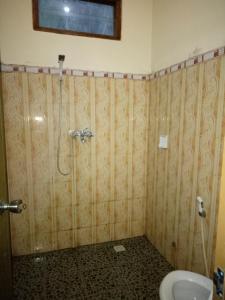 a bathroom with a shower and a toilet at Sintya Homestay in Ubud