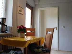 a yellow table and chairs with a plant on it at Peaceful Apartment in Klutz Germany near Boltenhagener Beach in Klütz