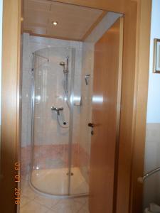 a shower with a glass door in a bathroom at Haus Loidl in Sankt Gallen