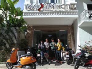 a group of people standing in front of a hotel at Maxim Hotel in Da Lat