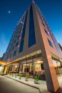 a building with a pyramid shaped facade at night at Braira Al Wezarat in Riyadh