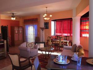a living room filled with furniture and a dining room at Semiramis Apartments in Ierapetra