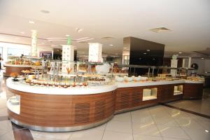 a restaurant with a counter with food on it at Green Nature Resort and Spa in Marmaris