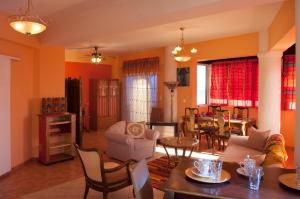 a living room filled with furniture and a dining room at Semiramis Apartments in Ierapetra
