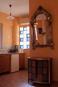 a kitchen with a mirror on the wall and a refrigerator at Semiramis Apartments in Ierapetra