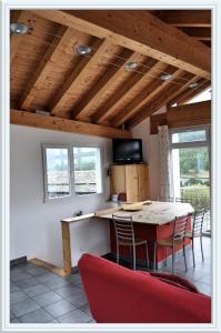 a kitchen with a table and chairs in a room at Chesa Tre Piz, Maloja in Maloja