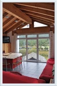 a living room with a table and a couch at Chesa Tre Piz, Maloja in Maloja