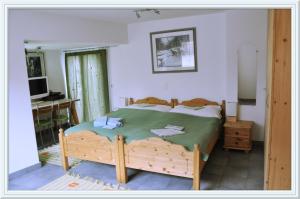 a bedroom with a bed and a desk and a television at Chesa Tre Piz, Maloja in Maloja