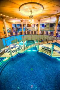 a pool on a cruise ship at night at Hotel Kapitany Wellness in Sümeg