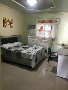 a bedroom with a bed and a chair and a window at Varanda Hotel in Arapiraca