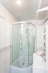 a shower with a glass door in a bathroom at Apartment with jacuzzi in Old Town in Kaunas