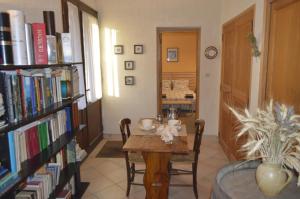 a dining room with a table and bookshelves at Le Domaine in Les Iffs
