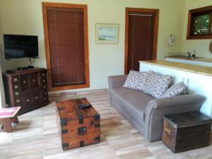 a living room with a couch and a coffee table at Sani Window B&B and Self catering in Underberg