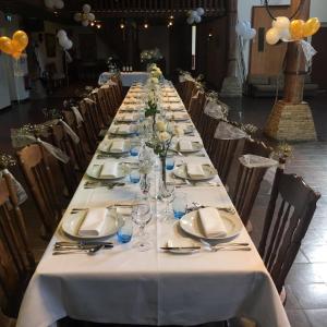 a long table with plates and wine glasses on it at Private Island De Sayter in Warten