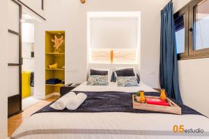 a bedroom with a large bed with blue curtains at Azotea de la Catedral in Toledo