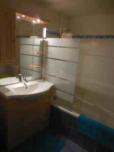 a bathroom with a sink and a shower at Gîte Toukoul in Autrans