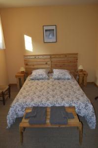 a bedroom with a large bed with two towels on it at Le Domaine in Les Iffs