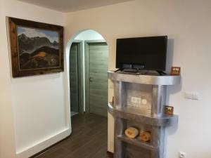 a living room with a tv and a tv stand in a room at Apartment KLEMEN in Bohinjska Bela