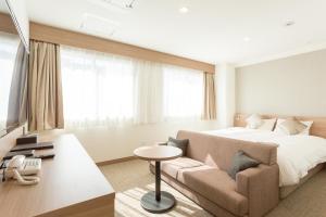 מיטה או מיטות בחדר ב-Shimizu City Hotel
