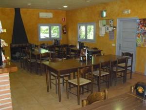 a dining room with tables and chairs in a restaurant at Mas Patxet in Santa Pau