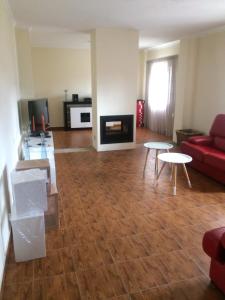 a living room with a red couch and tables at Monte Loureiro-caveira in Melides