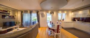 a kitchen and living room with a couch and a table at Villa Nena in Makarska