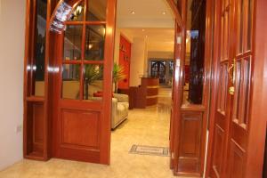 a hallway with wooden doors and a living room at La Mansion Casa Hotel in Andahuaylas