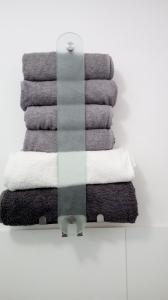 a stack of towels on a rack in a bathroom at Ferienwohnung mit Loggia in Münster